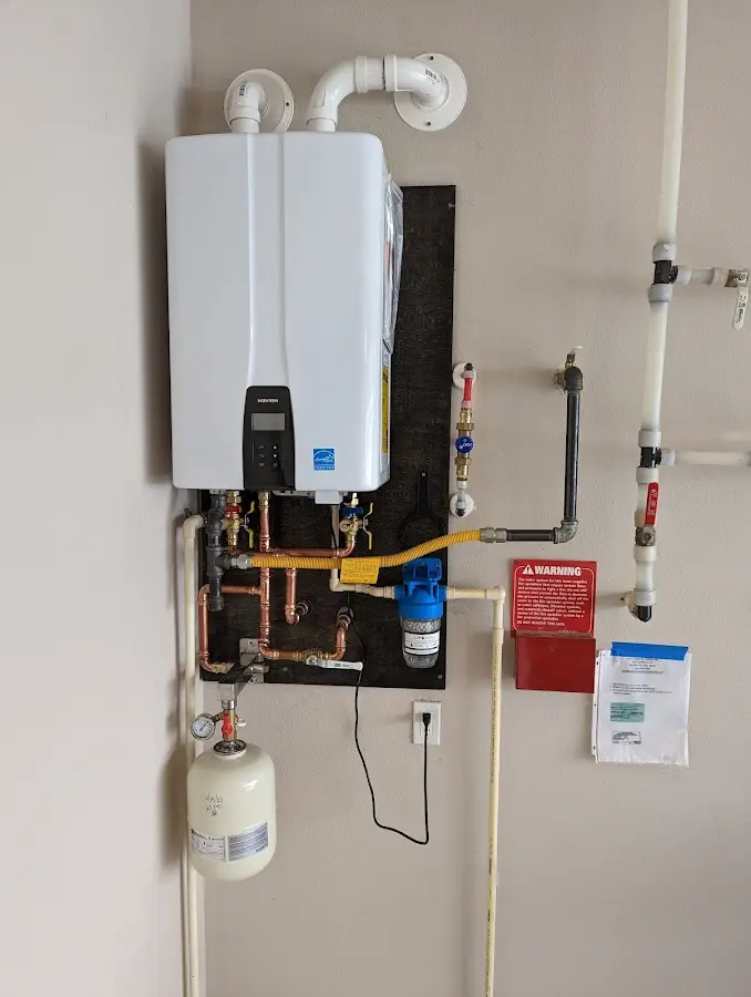 Professional plumber installing copper piping in a Florida Ridge home